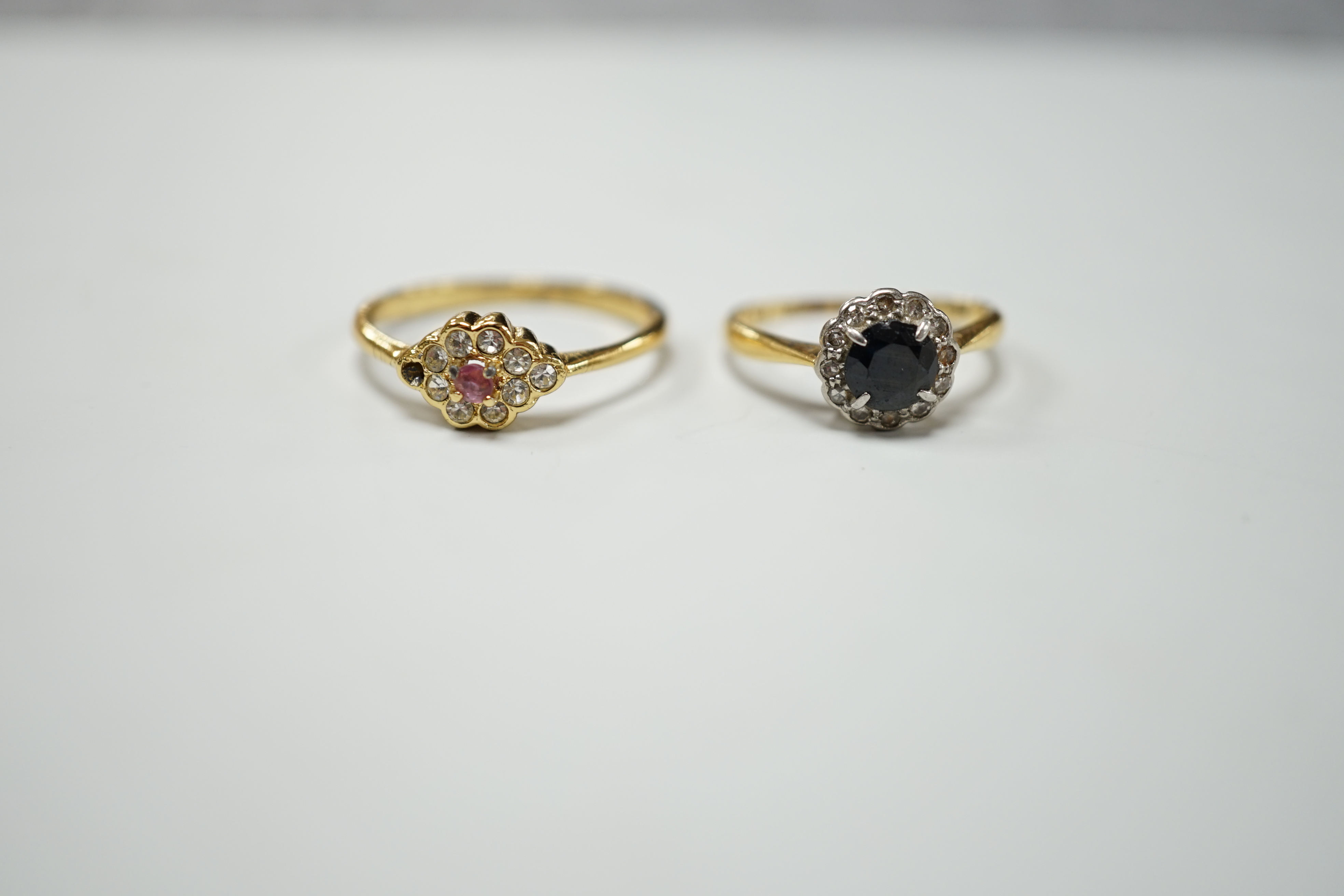 Four assorted diamond and gem set dress rings, comprising an 18ct gold sapphire and diamond cluster, size M, a gilt metal paste lacking one stone, size R, a 9ct gold diamond chip and sapphire, size L and an unmarked jet